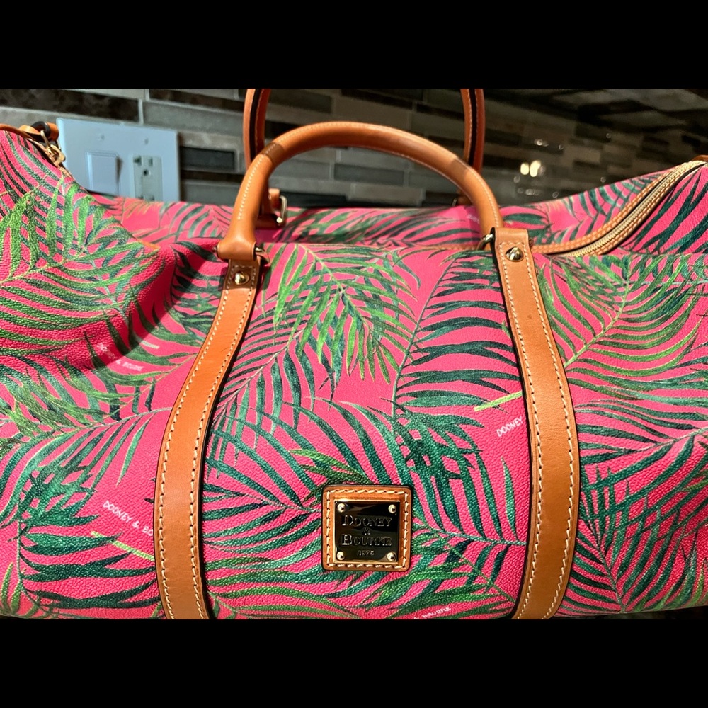 NWOT Dooney &Bourke duffle.Never used. Approximately 19”long, 10”high 11”wide.